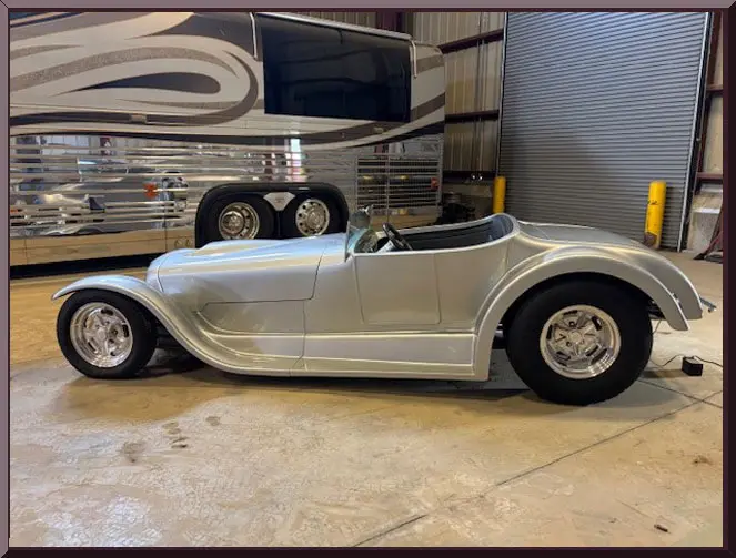 Retro vehicle beside a luxury bus
