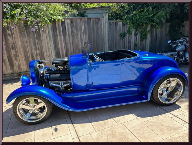 Classic blue roadster with chrome wheels