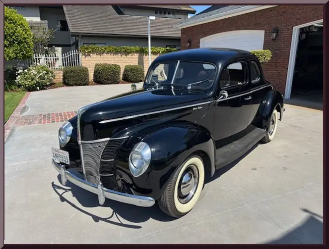 Classic black coupe near garage