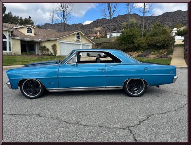 Vintage blue car with mountains