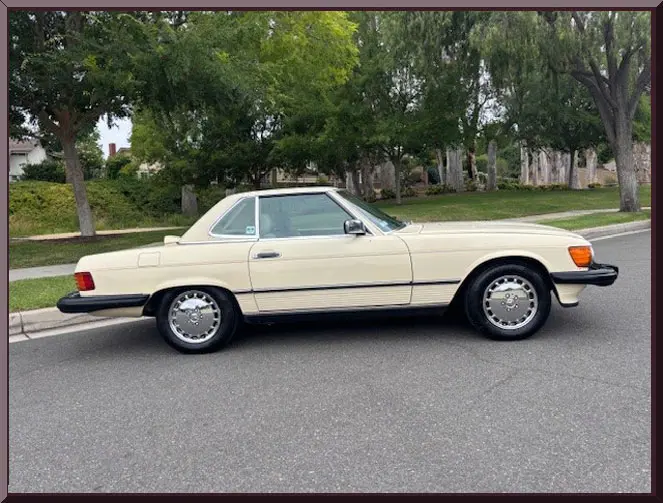 Classic white convertible parked on street