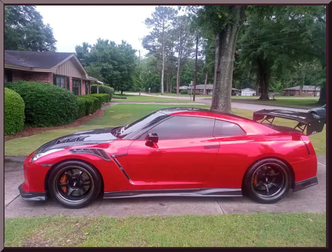 Sleek red car with black wheels