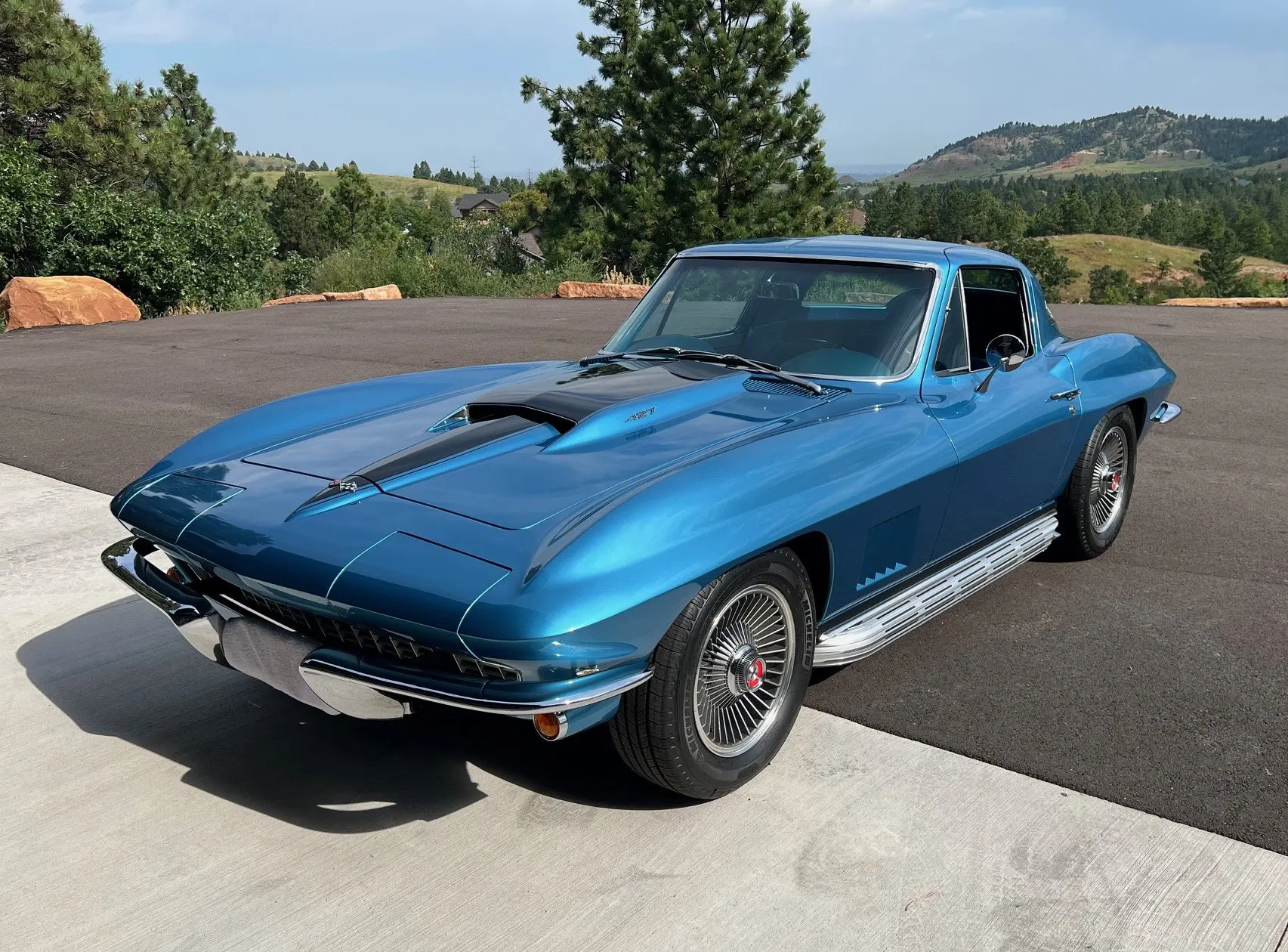 Classic blue Chevrolet Corvette parked outdoors on a sunny day.