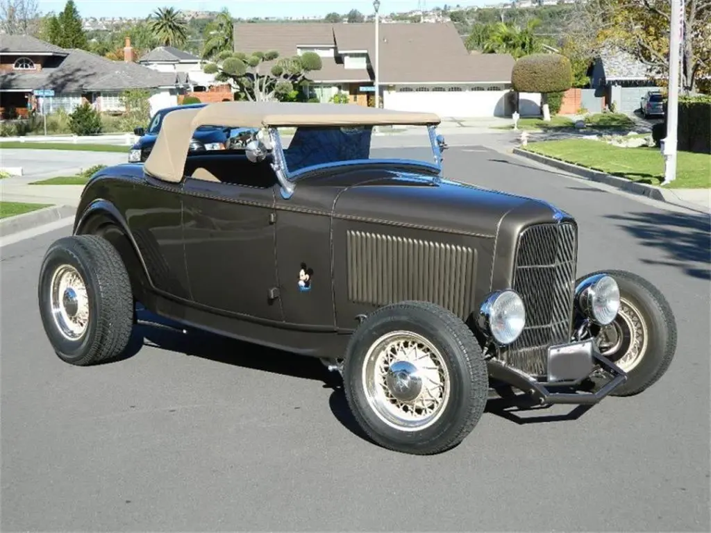 Black vintage hot rod convertible with tan top