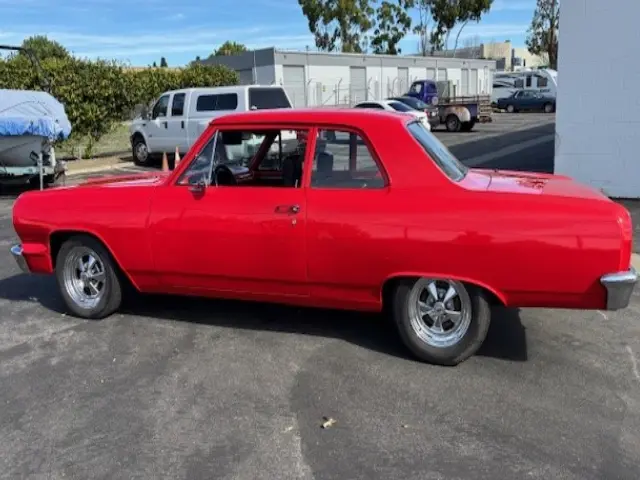 Red vintage two-door coupe parked outdoors