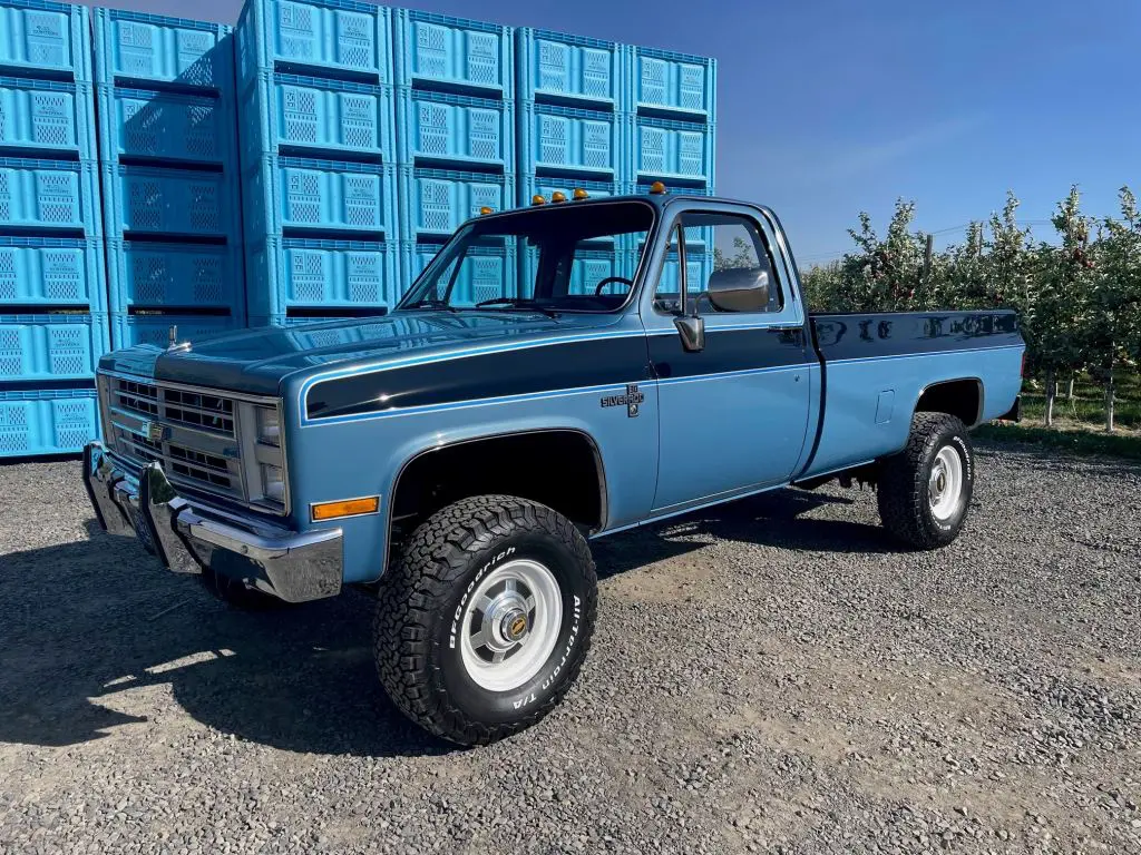 Vintage two-tone blue pickup truck, lifted