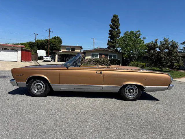 Classic bronze convertible parked in suburban street