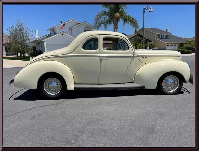 Cream vintage two-door coupe on suburban street