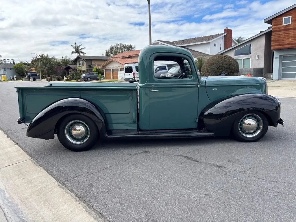 Classic green and black pickup truck parked
