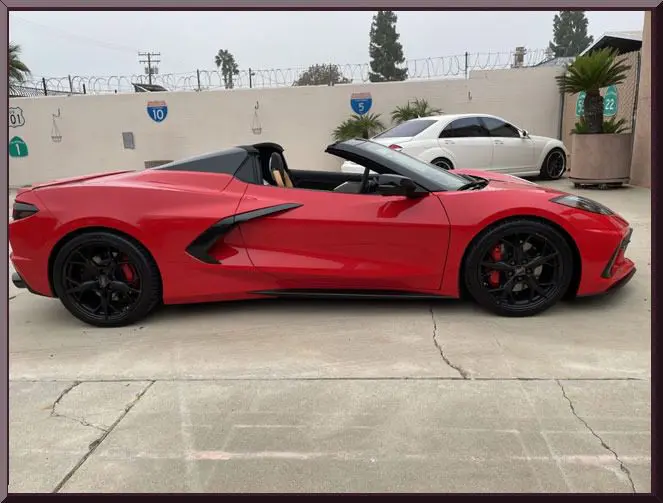 Red convertible sports car parked outside