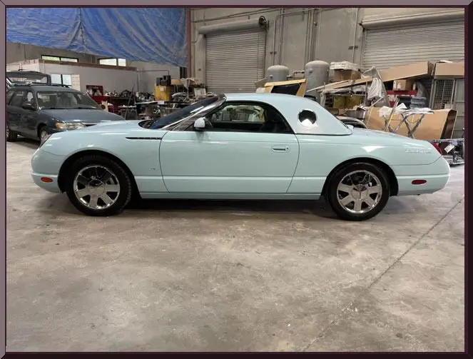 Light blue vintage car in garage