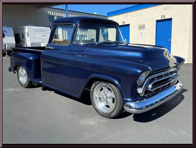 Retro pickup beside storage units
