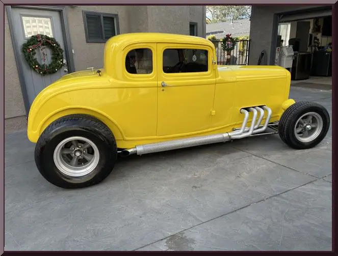 Retro yellow car on driveway