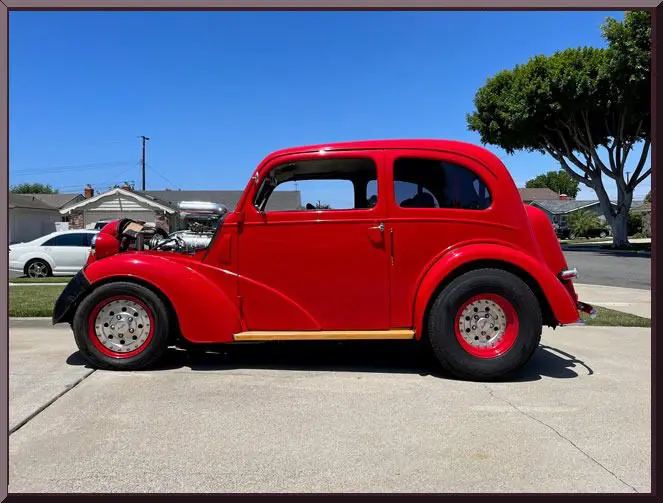 Red vintage car parked on driveway