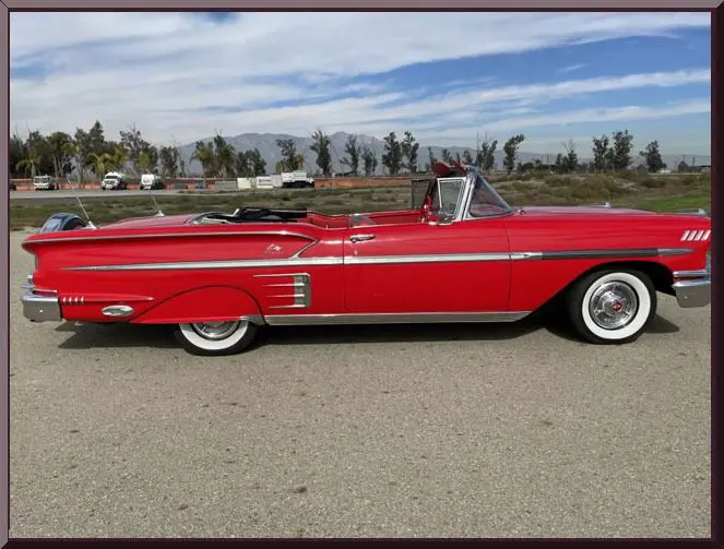 Vintage red car with whitewall tires