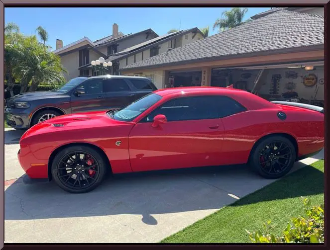 Sleek red car beside black SUV