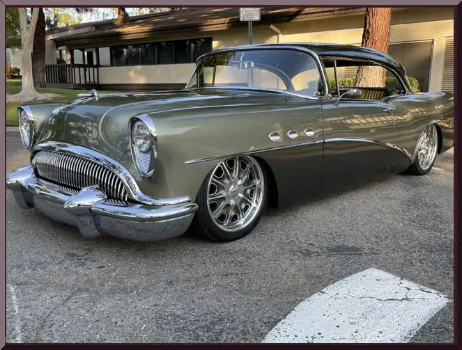 Olive green vintage car parked