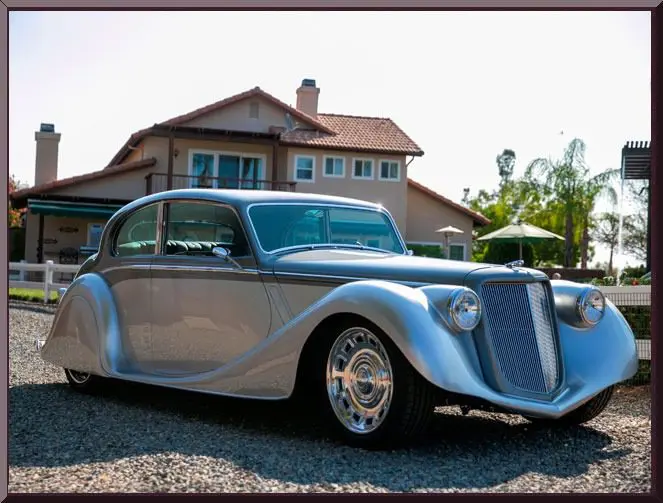 Vintage car parked on gravel driveway