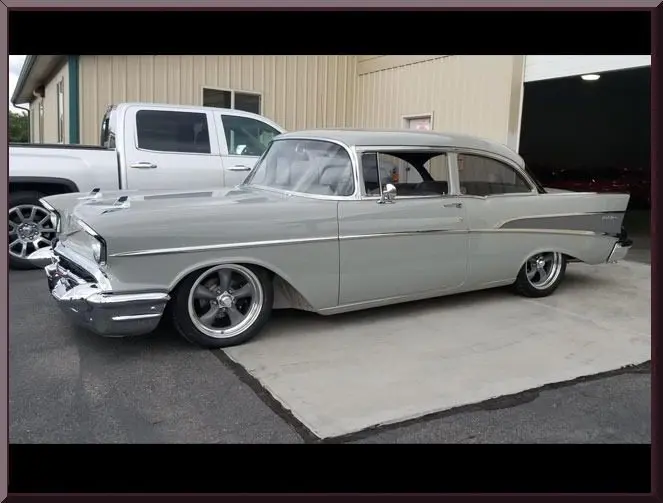 Classic gray car parked outside garage