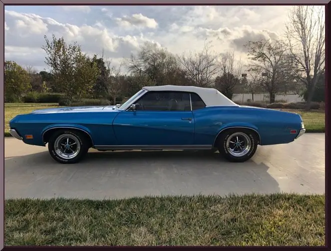 Classic blue convertible muscle car side profile