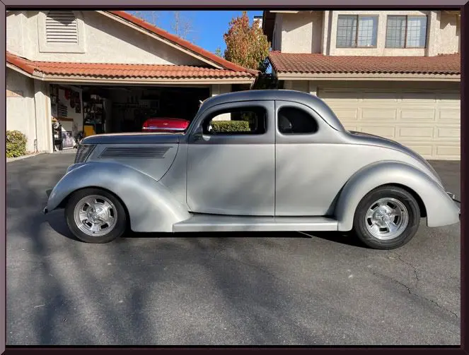 Classic silver car parked in driveway