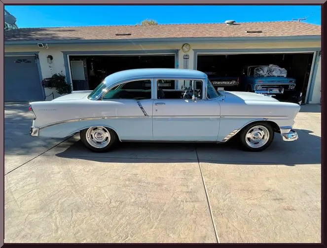 Classic blue car in driveway