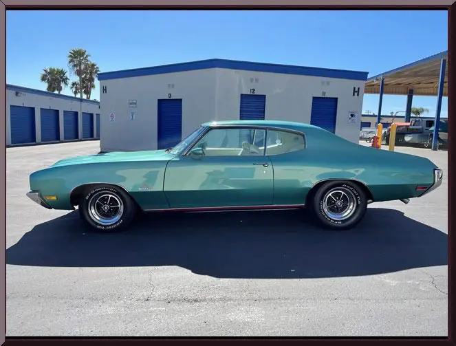Retro vehicle beside blue storage garages