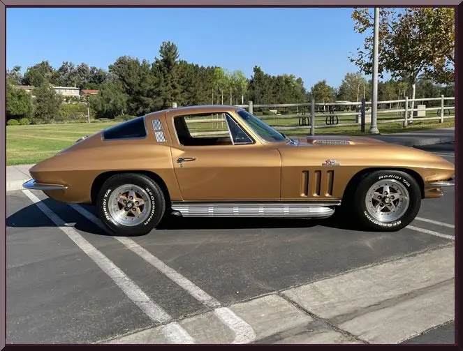 Gold classic Corvette coupe parked in lot