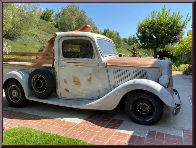 Classic truck parked in sunny garden