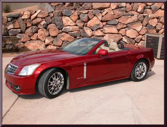 Luxury convertible car on concrete driveway