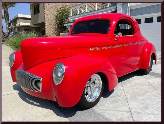Bright red antique car in sunlight