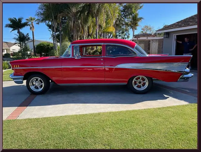Retro red automobile on sunny driveway