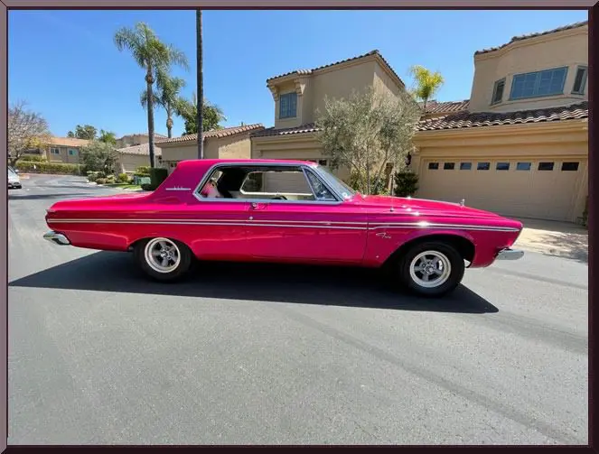 Retro pink car in neighborhood setting
