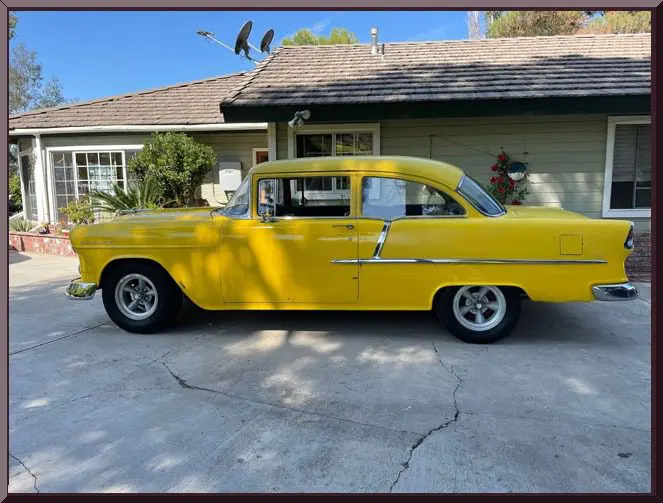 Retro yellow automobile beside home