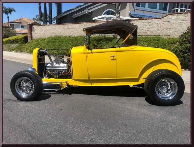 Classic yellow roadster with open top