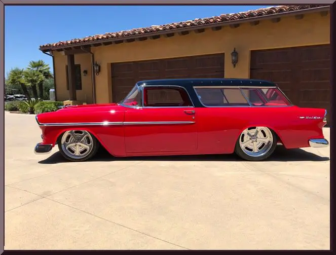 Red vintage car parked in driveway