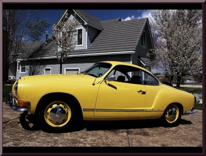 Yellow vintage car in driveway