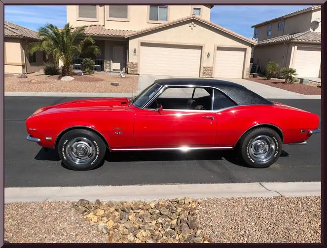 Red vintage car in suburban neighborhood
