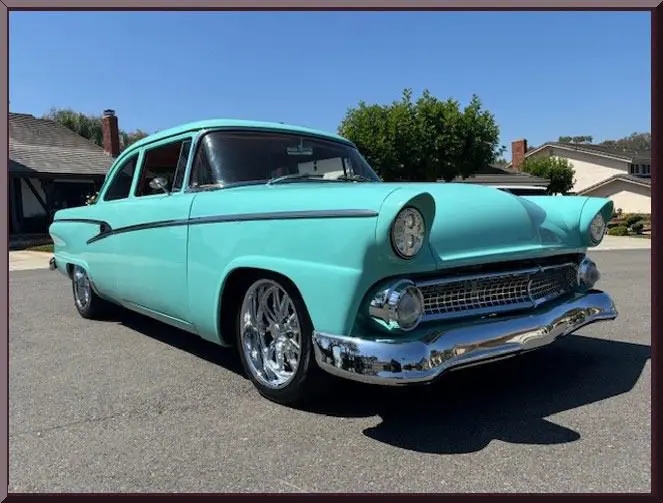 Vintage turquoise car parked on street