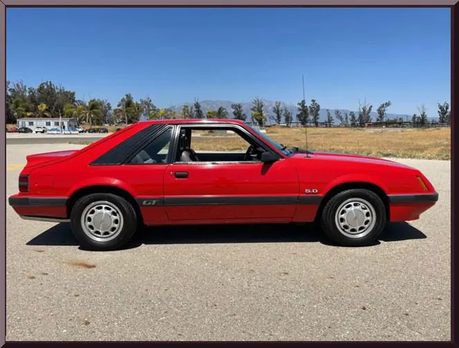 Red classic car parked on sunny day