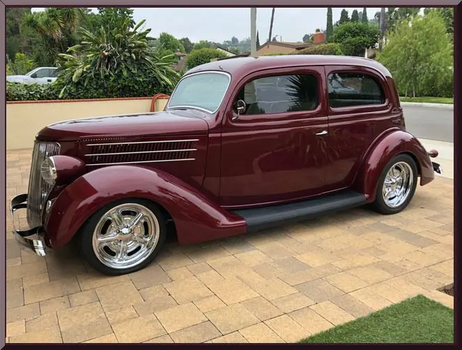 Vintage maroon car parked on driveway