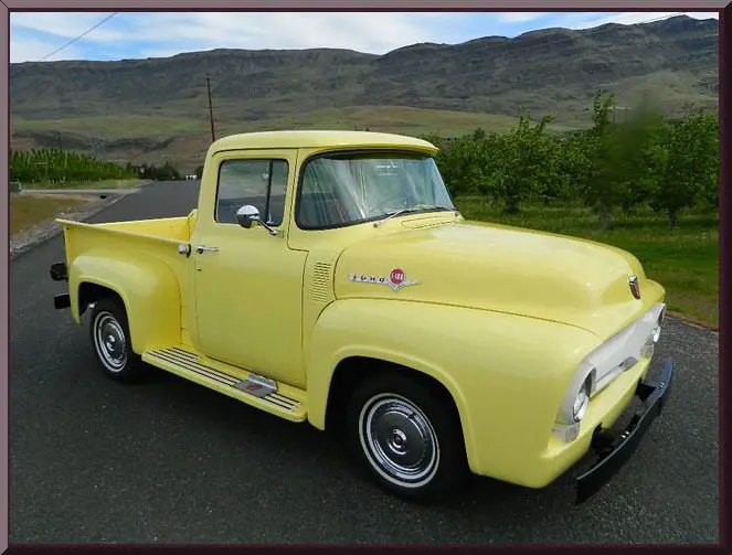Yellow vintage pickup truck on scenic road