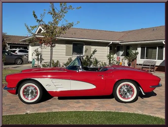 Classic car outside suburban house