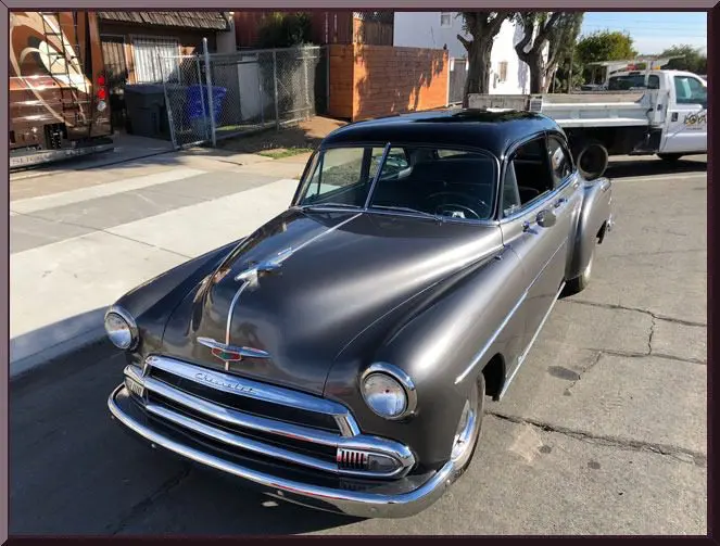 Classic gray car parked on street