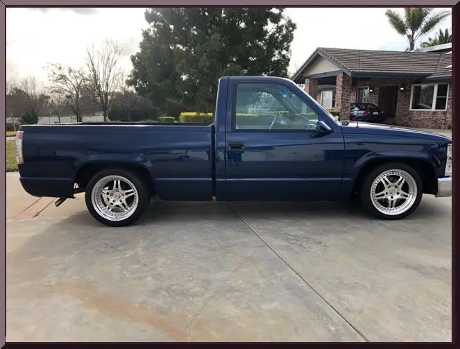 Classic pickup truck beside suburban house