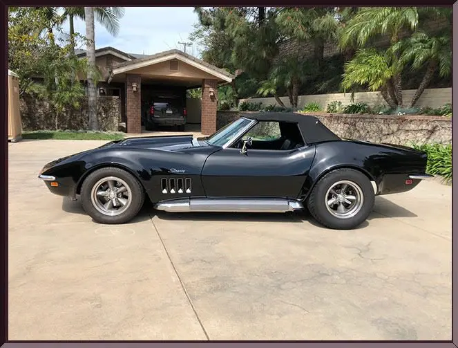 Classic car in front of a garage