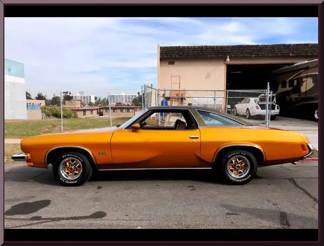 Retro car with chrome wheels on street