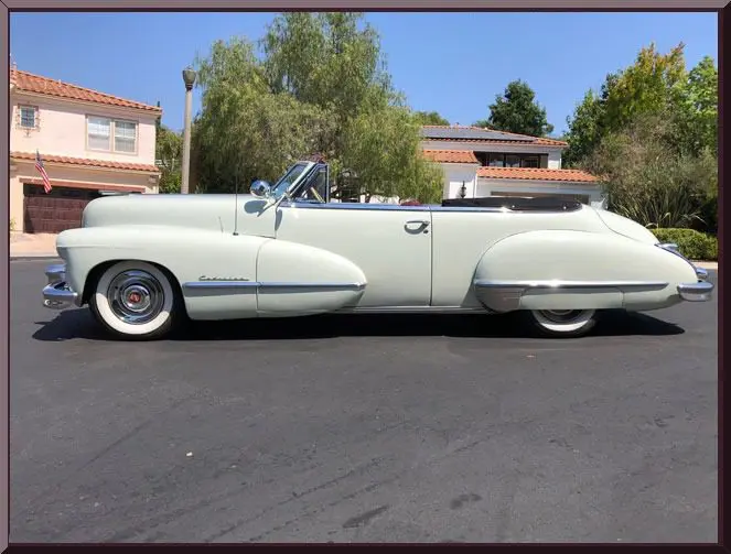 Classic convertible car parked on street