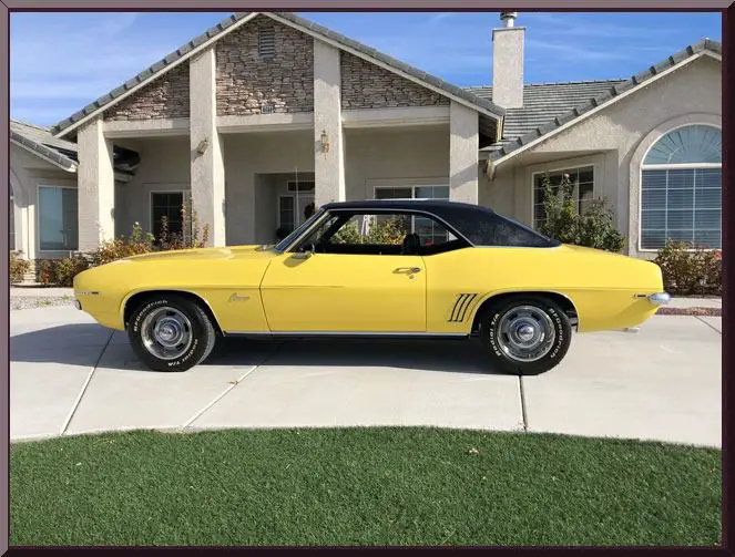Yellow vintage car parked in driveway
