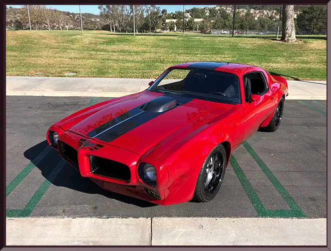 Red vintage muscle car on pavement